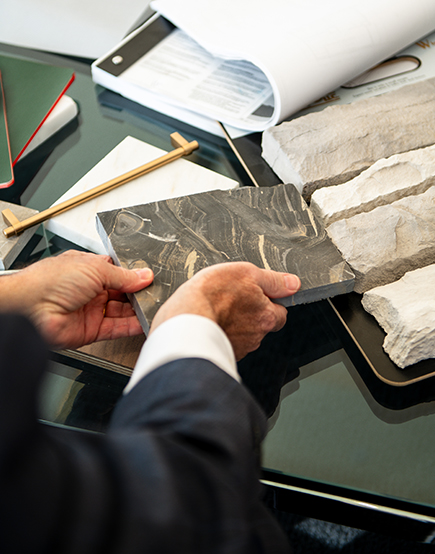 over the shoulder shot of a team members' hands holding rock samples