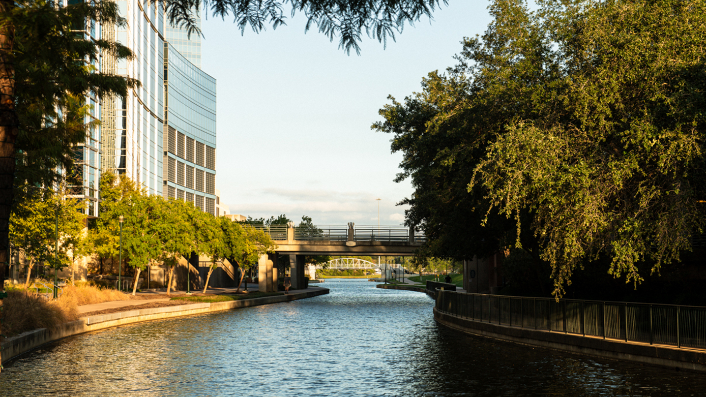 Wide shot of the waterway of the lake and part of an exterior building